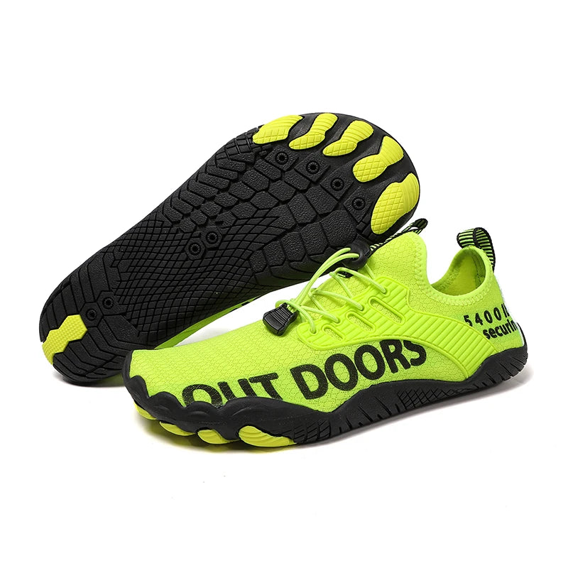 Neon green barefoot-style water shoes with black non-slip rubber soles, drainage holes, and adjustable bungee laces, displayed on a clean white background with one shoe showing the textured outsole and “OUT DOORS” text